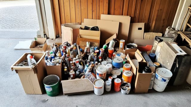 Sondermüll zur Entsorgung: Farbdosen, Spraydosen und Lacke in Kartons gesammelt am Wertstoffhof